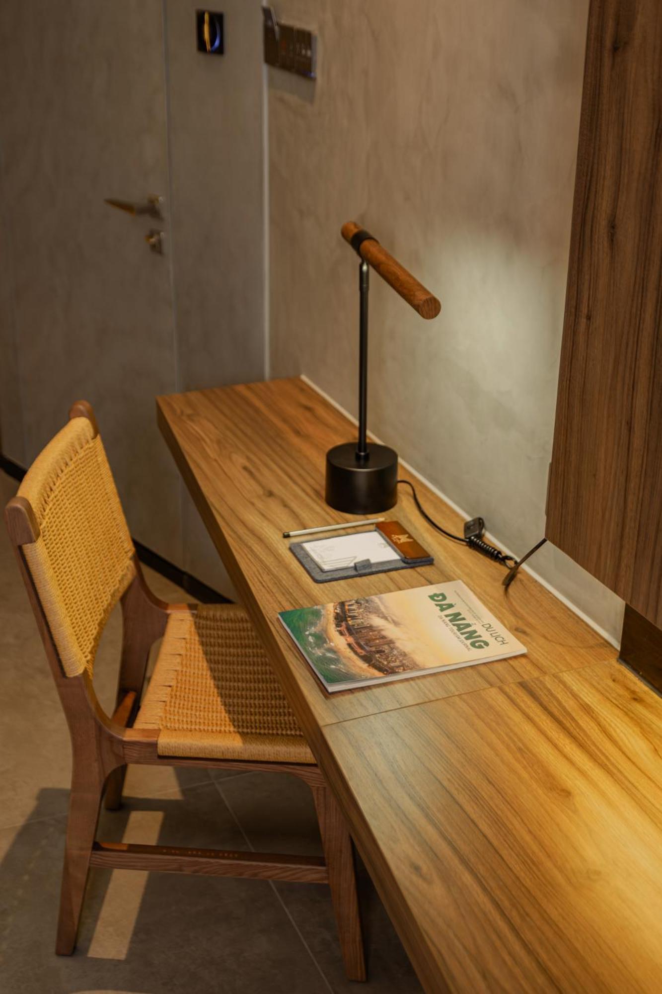 M Hotel Danang Экстерьер фото A desk with a magazine on it